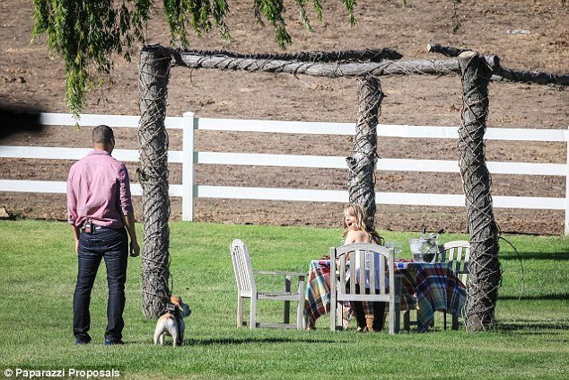 Complete surprise: Michael Yo approaches his girlfriend Claire Schreiner with their French bull dog Paul after convincing her they were going for a romantic meal at a winery 